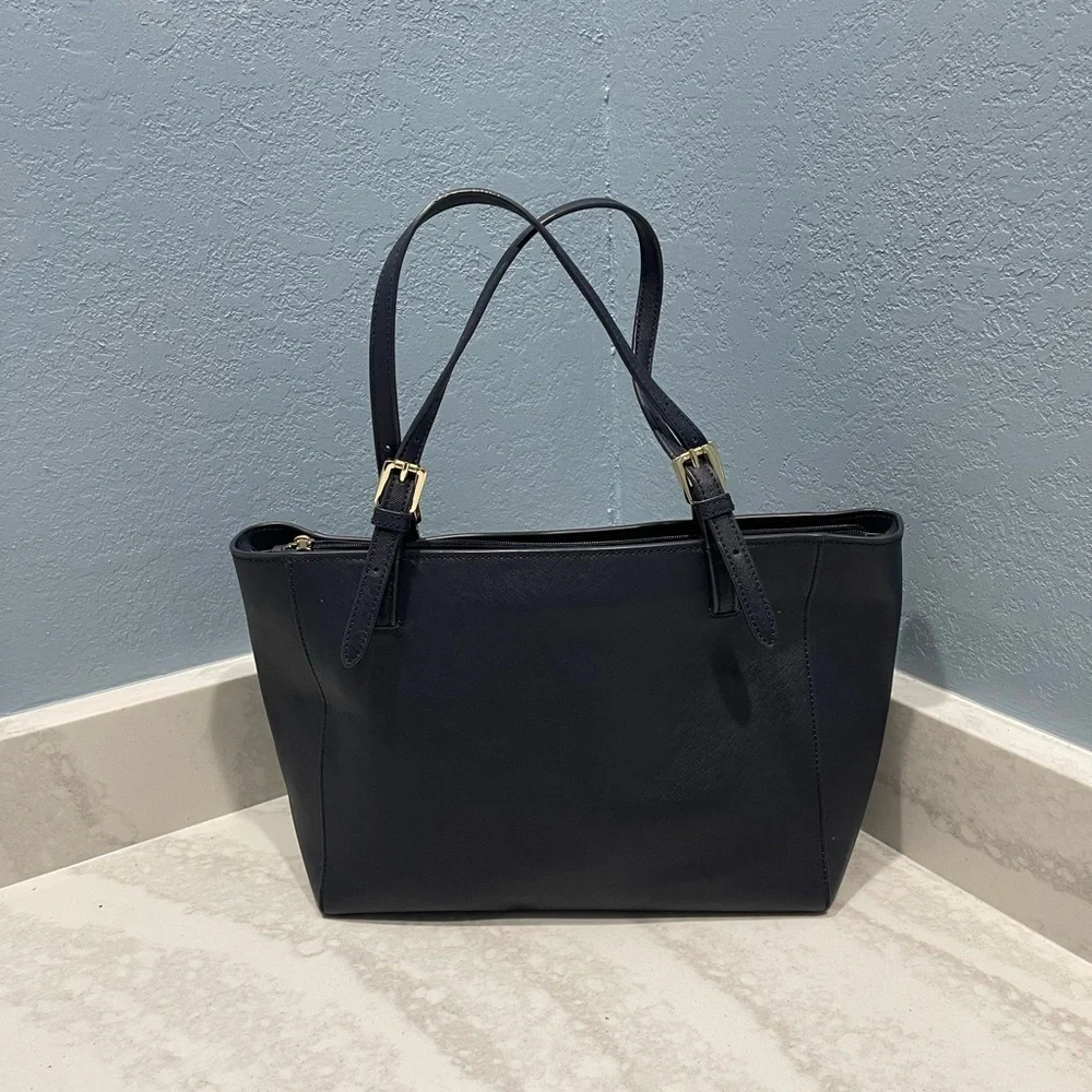 Tory Burch Saffiano leather medium Navy Blue top zip tote with material inside.